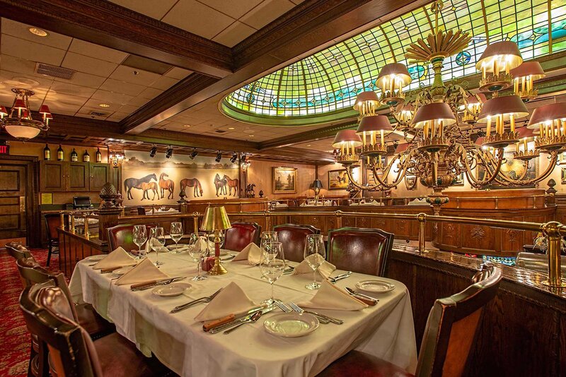 Upstairs dining room table with view of chandelier