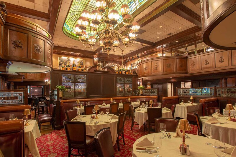 Dining room with view of chandelier and bar