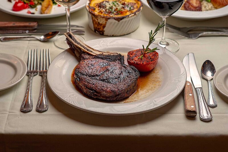 Steak entree with side of tomato and basil